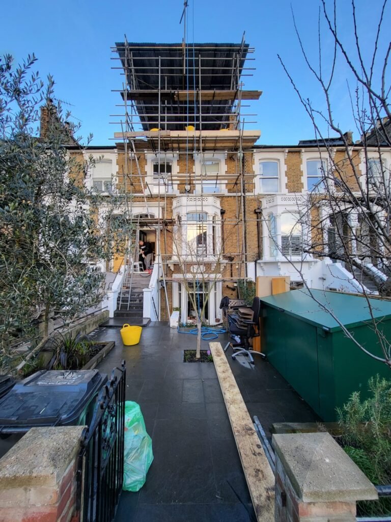 Scaffold erected on a Victorian terrace with a working platform at roof level